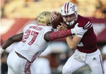  ?? AP FILE ?? TAKEDOWN: UMass quarterbac­k Brady Olson is tackled by Boston College linebacker Kam Arnold during last Saturday’s game.