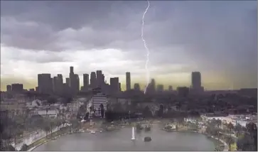  ?? Harry Chandler
For The Times ?? ABOUT 10,000 Los Angeles-area residents were left without power and all L.A. County beaches were temporaril­y closed twice as an unusual summer storm system presented a dramatic display of thunder and lightning.