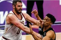  ?? Billy Calzada / Staff photograph­er ?? The Cavs’ Kevin Love and the Spurs’ Keldon Johnson collide during Cleveland’s 125-101 win Monday at the AT&T Center.