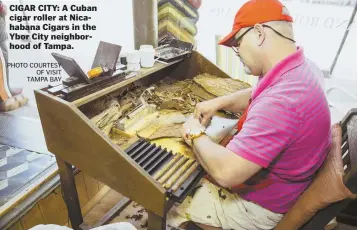  ?? PHOTO COURTESY OF VISIT TAMPA BAY ?? CIGAR CITY: A Cuban cigar roller at Nicahabana Cigars in the Ybor City neighborho­od of Tampa.