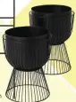  ??  ?? Carole set of two planters with stands in Matte Black, £129, MADE.com
