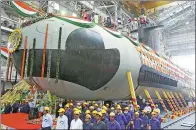  ?? SHAILESH ANDRADE / REUTERS ?? Employees stand in front of the Indian navy’s first submarine before being undocked in Mumbai in 2015.