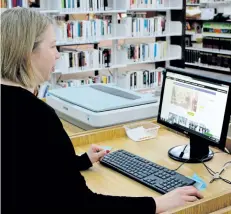  ?? HARLEY DAVIDSON/SPECIAL TO THE REVIEW ?? Lisa Martin, of the Niagara Falls Public Library, checks out the library's openaccess ancestry program, which allows people to track their heritage for free.