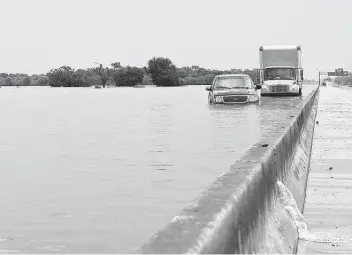  ?? Yi-Chin Lee / Staff file photo ?? Vehicles flooded by Tropical Storm Imelda sit in the westbound lanes of Interstate 10 in Winnie on Sept. 20, 2019. Similar flooding had occurred after Hurricane Harvey.