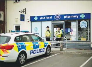  ?? AP PHOTO ?? British police officers guard a cordon outside a branch of the Boots pharmacy in Amesbury, England, Wednesday.