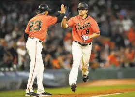  ?? Santiago Mejia / The Chronicle ?? Alex Dickerson, highfiving thirdbase coach Ron Wotus after hitting a home run on Friday night, has become one of the team’s mustwatch players.