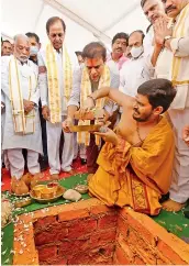  ??  ?? Chief Minister K. Chandrashe­kar Rao and IT minister K.T. Rama Rao offer prayers during religious rituals for the new TRS party office in New Delhi on Thursday.