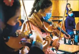  ?? Marcus Yam Los Angeles Times ?? THE ZOHRA ORCHESTRA rehearses in Kabul. The all-female group, formed in 2015, seems certain to draw the ire of the Taliban, which frowns on music.