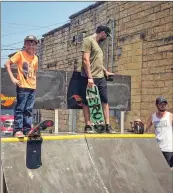  ?? ?? Riley Stott, left, and Batesville resident Josh Harris prepare to skate on a makeshift ramp in downtown Batesville last summer for a crowd.