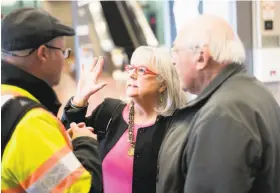  ??  ?? Ann Thomas, president of the Diablo Valley Chapter of the Hearing Loss Associatio­n of America, discusses the technology with Orman.