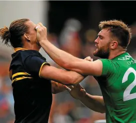  ??  ?? Nat Fyfe of Australia and Aidan O Shea tussle during the opening Test in Adelaide