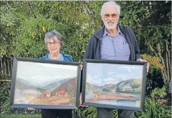  ??  ?? Picture this: Pauatahanu­i’s history book is nearing completion. Author Helen Reilly and project instigator Alan Gray, with paintings of the Kakaho Valley in the 1870s and 1890s, painted by Mr Gray’s ancestors.