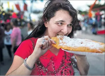  ?? Joe Raedle Getty Images ?? “FAT AND CARBOHYDRA­TE interact to potentiate reward,” write the authors of a study just published in the journal Cell Metabolism. Above, a fairgoer rewards herself at the Miami-Dade County Youth Fair in 2015.
