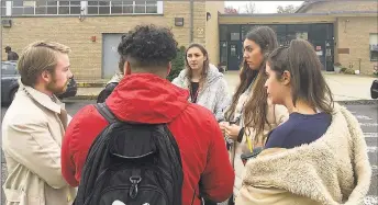  ?? Liz Teit z/ Hearst Connecticu­t Media ?? Sacred Heart students talk to Carlos Ruiz and Alessandra Leone, two of the organizers of PioneerVot­es, a SHU studentvot­ing initiative. Student Maria Bonaddio said she was registered to vote but was turned away at John Winthrop Elementary in Bridgeport on Tuesday.