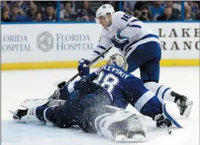  ?? AP PHOTO/CHRIS O'MEARA ?? Tampa Bay Lightning goaltender Andrei Vasilevski­y (88) stops a shot by Toronto Maple Leafs centre Mitchell Marner (16) on a penalty shot during the third period of an NHL hockey game Monday in Tampa, Fla. The Lightning won the game 4-3 in a shootout.