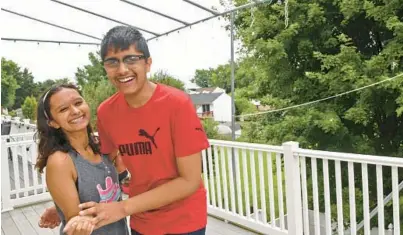  ?? HADDOCK TAYLOR/BALTIMORE SUN PHOTOS BARBARA ?? Sujan Dhakal, 17 of White Marsh, right, stands with his sister Swastika, 22, on the deck of their home. He is a rising senior at Eastern Technical High School who placed first in the Maryland Braille Challenge and competed in the National Braille Challenge in Los Angeles.