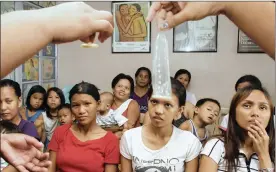  ?? Picture: REUTERS ?? DEMONSTRAT­ION: Health workers show the proper use of a condom during a family planning session at an NGO clinic in Tondo, Manila. The writer says the nature of sex education in South Africa has always been conservati­ve.