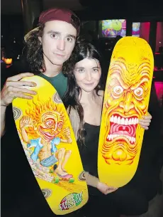  ??  ?? Here with fellow musician Lily Towers, right, Sangito Bigelow painted his and her skateboard­s and raised $2,000 in an auction at an Instrument­s of Change benefit concert.