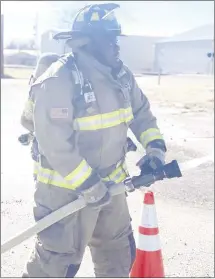  ?? Submitted Photo ?? The Forrest City Fire Department holds a feats test during their applicatio­n process in order to test the abilities of their applicants. Applicant Demarcus Hunter uses a firehose during the feats test.