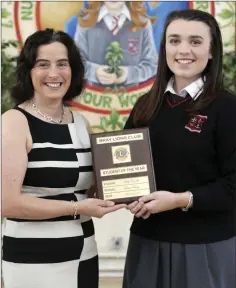  ??  ?? Molly Comish is presented with the Lions Club Student of the Year Award by principal Emma Raughter.