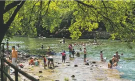  ?? ILANA PANICH-LINSMAN/NEW YORK TIMES ?? People cool off at Ladybird Lake in Austin, Texas, on Wednesday. The world has entered a ‘new and dangerous phase’ of the coronaviru­s pandemic, a top official from the World Health Organizati­on said Friday.