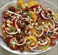  ?? PHOTO BY CATHY THOMAS ?? Use tomatoes of different varieties, sizes and colors to serve with herbs and almond vinaigrett­e.