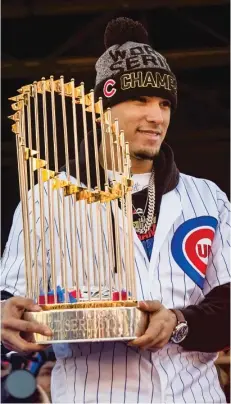  ?? ASHLEE REZIN GARCIA/SUN-TIMES (LEFT), AP ?? Javy Baez holds the World Series trophy in November 2016. Theo Epstein presents Kris Bryant with his World Series ring in April 2017. None of the three is with the Cubs any longer.