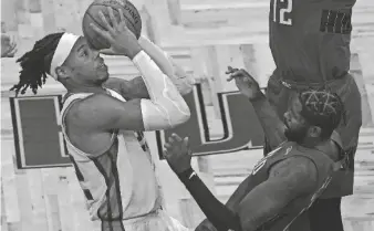  ?? PHELAN M. EBENHACK/AP ?? Kings center Richaun Holmes, left, is fouled by Magic forward James Ennis III, front right, while driving to the basket on Wednesday.