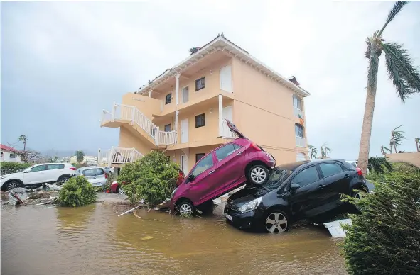  ?? — GETTY IMAGES ?? Cars sit piled on top of one another in Marigot, on the French side of Saint Martin, after the passage of Hurricane Irma. France, the Netherland­s and Britain on Thursday sent water, food and rescue teams to their storm-stricken territorie­s in the...