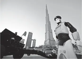  ?? GIUSEPPE CACACE, AFP/GETTY IMAGES ?? The world’s first operationa­l police robot stands at attention in Dubai on May 31.