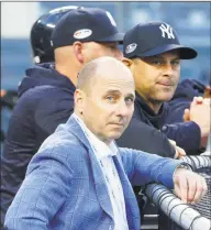  ?? Jim McIsaac / Getty Images ?? Yankees General Manager Brian Cashman and manager Aaron Boone watch batting practice before Game 4 of the 2018 ALDS against the Boston Red Sox at Yankee Stadium.