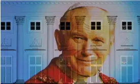  ?? March. Photograph: Kuba Stężycki/Reuters ?? A picture of Pope John Paul II projected onto the presidenti­al palace in Warsaw, Poland in