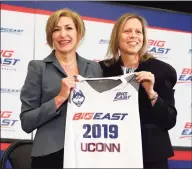  ?? Richard Drew / Associated Press ?? Fromer UConn president Susan Herbst, left, and Big East Commission­er Val Ackerman, pose for photos at the announceme­nt that the Huskies were re-joining the conference last year in New York. According to a source, the Big East women’s basketball coaches are in favor of keeping 20-game conference schedule.