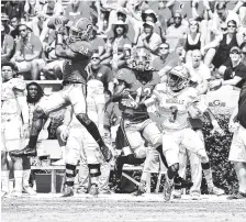  ?? PERRY MCINTYRE JR./GEORGIA PHOTO ?? Georgia strong safety Dominick Sanders (24) snags an intercepti­on during last season’s 26-24 escape of Nicholls State.