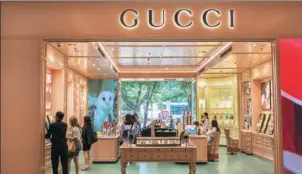  ?? PROVIDED TO CHINA DAILY ?? Consumers shop at a Gucci beauty store in a department store in downtown Shanghai on June 11.