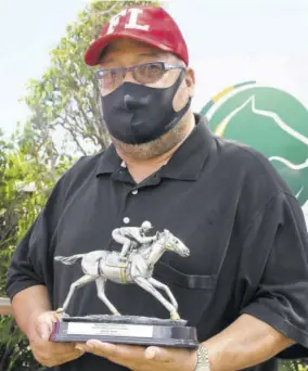  ??  ?? Trevor James, owner of Sentient, proudly displays the Chairman’s Trophy.