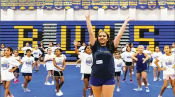  ?? PHOTO VINCENT OSUNA ?? Brawley Union High competitiv­e cheerleade­r Rachely Contreras leads young camp goers in a routine during the 2019 Future Wildcat Cheer Camp on Saturday at BUHS in Brawley.