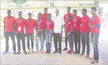  ??  ?? President David Granger, poses with the contingent of athletes which returned home yesterday to a hero’s welcome at State House after racing into the record books at the recent Flow CARIFTA Games in Curacao.