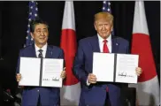  ?? EVAN VUCCI / ASSOCIATED PRESS ?? President Donald Trump meets with Japanese Prime Minister Shinzo Abe during the United Nations General Assembly on Wednesday in New York to trumpet their newly signed trade deal.