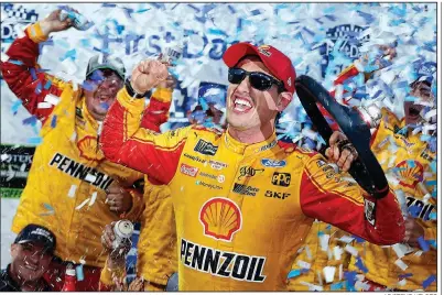  ?? AP/STEVE HELBER ?? Joey Logano celebrates after winning Sunday’s Monster Energy NASCAR Cup Series race at Martinsvil­le Speedway in Martinsvil­le, Va. Logano led a race-high 309 of the 500 laps but had to contend with Penske teammate Brad Keselowski in the waning laps.