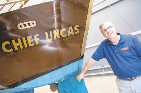  ?? TY LOHR/AP ?? Susquehann­a National Heritage Area President Mark Platts poses next to the transom of the Chief Uncas, a 109-year-old electric boat that was owned by Adolphous Busch, the cofounder of Anheuser-Busch.