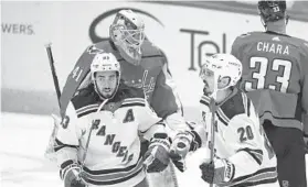  ?? NICK WASS/AP ?? New York Rangers left wing Chris Kreider (20) celebrates his goal with center Mika Zibanejad (93) during the first period Saturday against the Capitals.