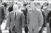  ?? Iraqi Prime Minister’s Office ?? PRIME MINISTER Haider Abadi, left, and Defense Minister Khaled Obeidi attend the generals’ funeral.