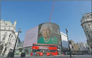  ?? (File Photo/AP/Kirsty Wiggleswor­th) ?? An image of Britain’s Queen Elizabeth II and quotes from her historic television broadcast commenting on the coronaviru­s pandemic are displayed April 9 on a big screen at Piccadilly Circus in London.