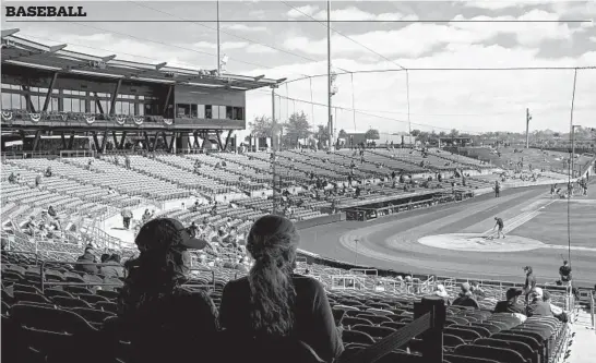  ?? ARMANDO L. SANCHEZ/CHICAGO TRIBUNE PHOTOS ?? White Sox fans take their seats before recent spring training games against the Brewers at Camelback Ranch in Glendale, Ariz and at Cubs fans at Peoria Sports Complex in Peoria, Ariz. during a game against the Padres. ( below center).