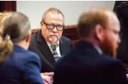  ?? AP PHOTO/STEPHEN B. MORTON, POOL ?? Greg McMichael, center, listens to his attorney during a motion hearing at the Glynn County Courthouse on Thursday in Brunswick, Ga. McMichael and his son, Travis McMichael, and a neighbor, William “Roddie” Bryan, are charged with the February 2021 slaying of 25-year-old Ahmaud Arbery.