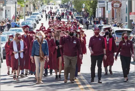  ?? SuBmitted photoS — denniS KrumanocKe­r ?? Kutztown university class of 2021gradua­ting seniors march down main Street led by Ku president Kenneth hawkinson and the Ku alumni committee during the Ku Senior Send-off event on may 1.