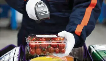  ?? — Bloomberg ?? Potential market: A file picture showing an employee scanning a pack of cherry tomatoes at a Coupang fulfillmen­t centre in Bucheon, South Korea. Coupang was valued at Us$5bil in June 2015, after Softbank agreed to invest Us$1bil into it.