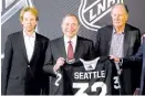  ?? STEPHEN B. MORTON/AP ?? Jerry Bruckheime­r (from left), NHL commission­er Gary Bettman and David Bonderman announce Seattle as the league’s 32nd franchise.