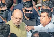  ?? — PTI ?? Union home minister Amit Shah and West Bengal BJP leader Suvendu Adhikari leave after meeting the deceased BJYM worker Arjun Chaurasia’s family members, at Kashipur near Kolkata, on Friday.
